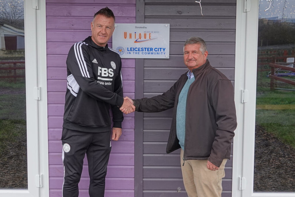 Leicester City Football Club legend and former captain, Steve Walsh (left), and Gary Burrows, senior project manager at Unique (right), at the handover of the new French doors installed at Gorse Hill City Farm.